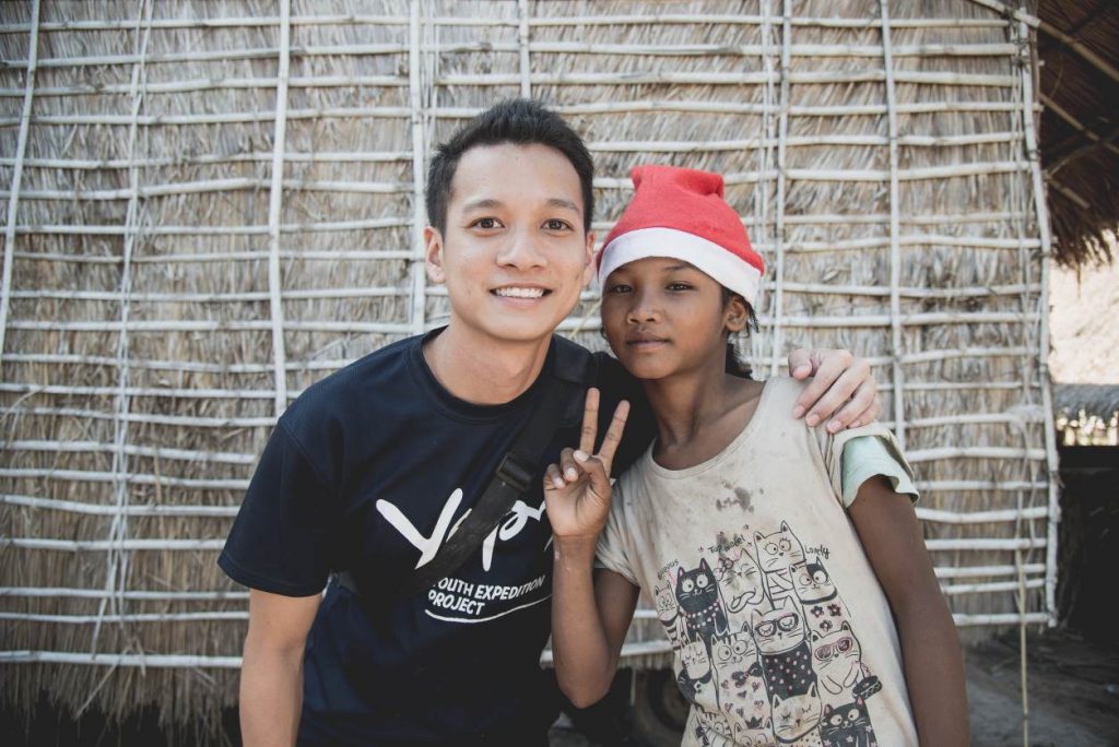 charity worker posing with young girl