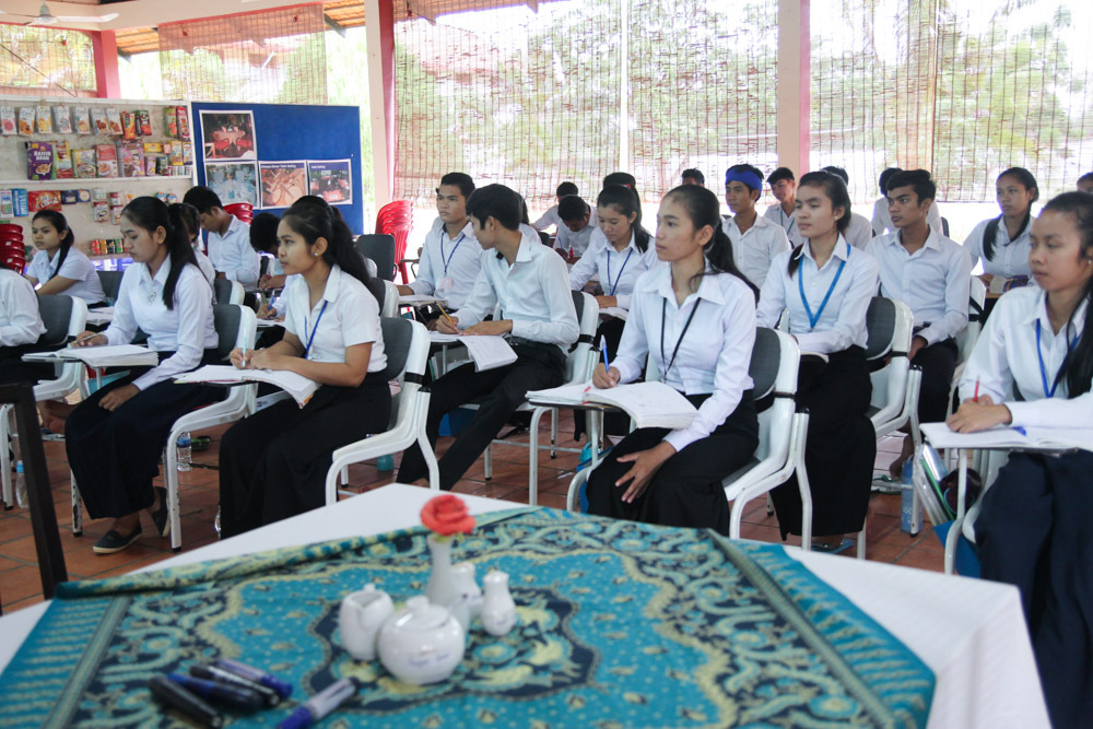 students inside classroom listening intently